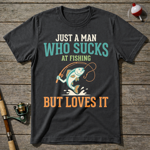 Sucks At Fishing But Loves It T-Shirt — Charcoal